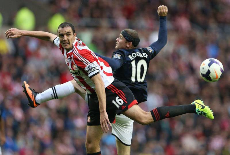 Wayne Rooney (right) battles John O'Shea (left) for the ball during Manchester United's 2-1 defeat of Sunderland. Ian MacNicol / AFP