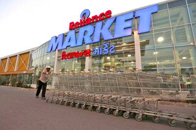 A worker pushes trolleys outside a Reliance Market superstore in Ahmedabad, India. Reuters