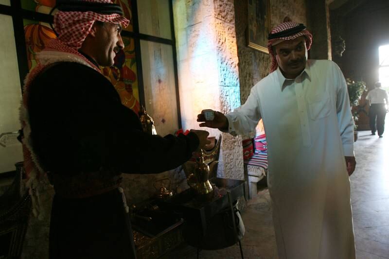 AMMAN, JORDAN: Abderrahman al-Isa (R), a Saudi tourist enjoys a traditional arabic coffee in a restaurant in Amman, Jordan July 30, 2008 as spends with the family their summer vaccation in Jordan. (Salah Malkawi/ The National)