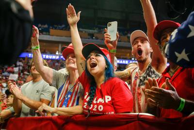 Attendees cheer while US President Donald Trump speaks during his campaign rally. Tulsa World via AP