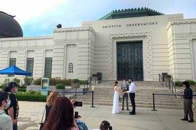 Brianda Mendivil and Christian Reyes wear face masks as they are married by Jacob Jurado in front of of Griffith Observatory in Los Angeles, California, USA. AFP