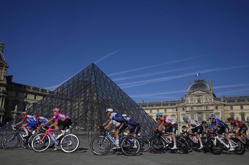 Riders passing the Louvre in Paris. Reuters