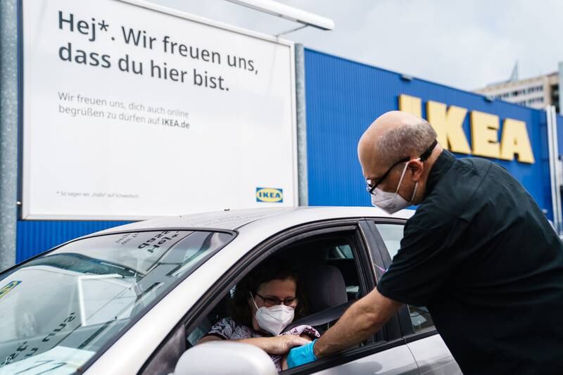 A motorist is immunised against Covid-19 in the car park of an Ikea store in Berlin, Germany.