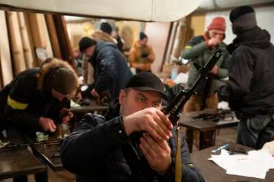Territorial defence members prepare to head out on patrol in Kiev. EPA