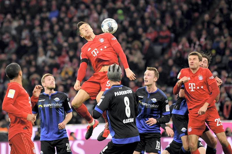 MUNICH, GERMANY - FEBRUARY 21: Robert Lewandowski of Bayern Munich jumps for the ball with during the Bundesliga match between FC Bayern Muenchen and SC Paderborn 07 at Allianz Arena on February 21, 2020 in Munich, Germany. (Photo by Sebastian Widmann/Bongarts/Getty Images)