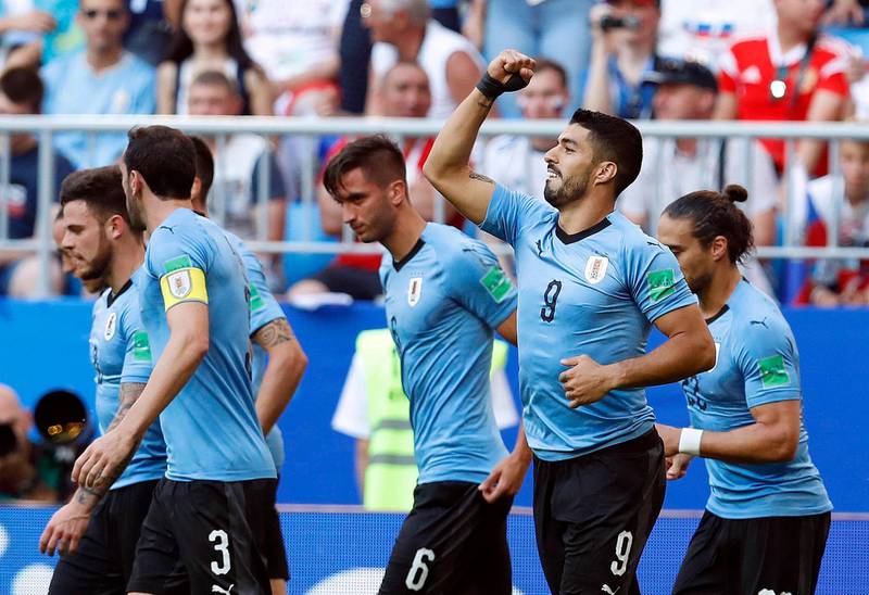 Uruguay's Luis Suarez, second from right, celebrates after scoring his side's first goal during the group A match between Uruguay and Russia at the 2018 soccer World Cup at the Samara Arena in Samara, Russia, Monday, June 25, 2018. (AP Photo/Hassan Ammar)