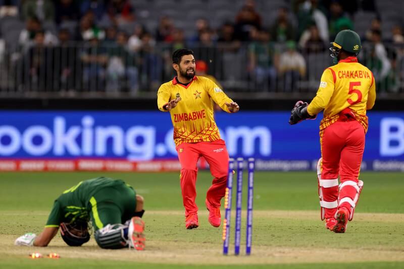 Sikandar Raza of Zimbabwe celebrates with Regis Chakabva after taking the wicket of Shan Masood of Pakistan during their T20 World Cup 2022 match, which the African team won. EPA