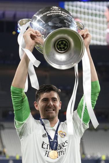 Real Madrid's goalkeeper Thibaut Courtois holds the trophy after the Champions League final soccer match between Liverpool and Real Madrid at the Stade de France in Saint Denis near Paris, Saturday, May 28, 2022.  (AP Photo / Frank Augstein)
