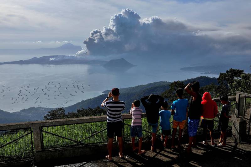 Residents look at the erupting Taal Volcano in Tagaytay City, Philippines, on January 13, 2020. Reuters