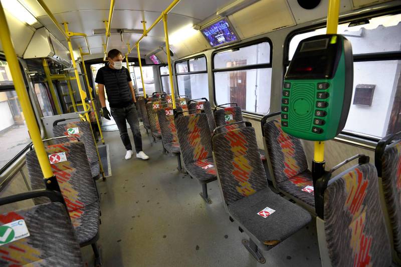 A driver checks social distancing markers on the seats of his tram, before leaving the garage in Sarajevo, Bosia.  AFP