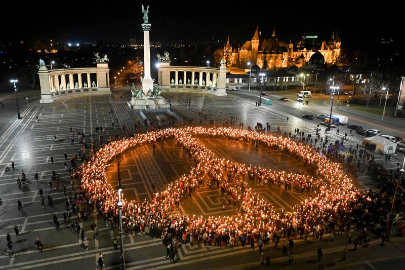 Protestors against the war and Russian invasion of Ukraine form a peace symbol during a demonstration at Heroes' Square in central Budapest, on March 9, 2022. AFP