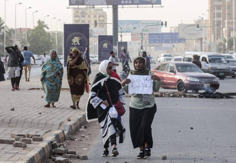 Sudanese protesters carry a placard during a rally in the capital Khartoum to condemn the "massacre" of five demonstrators including four high school students at a rally in a central town of Al-Obeida. AFP