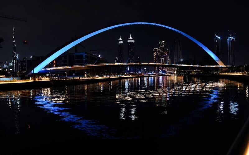 A bridge over the Dubai Water Canal lights up blue in support of Autism Awareness Month. Courtesy, WAM
