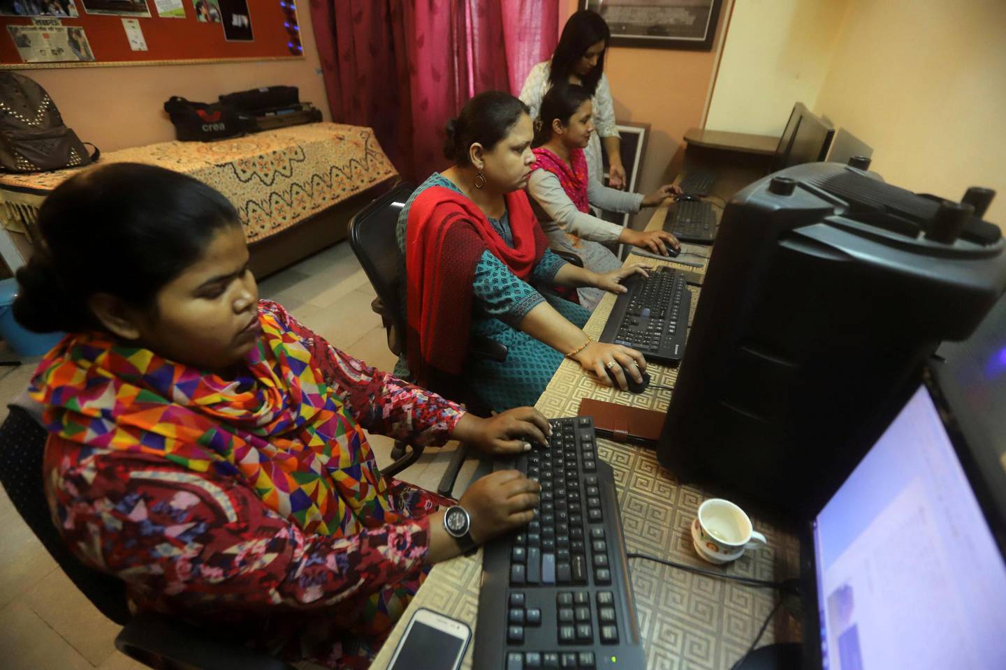 Muslim woman and girl work on video editing at an institute in Lucknow, April 7, 2019. The National/Jitendra Prakash 