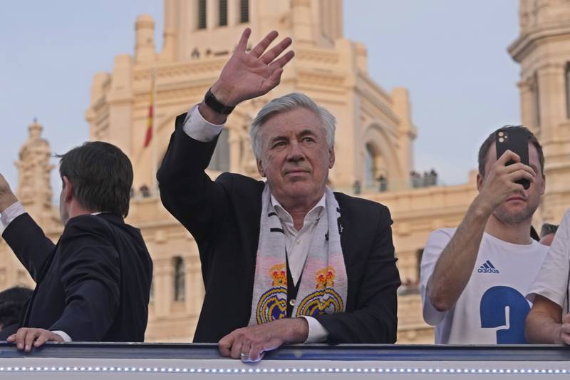 Real Madrid manager Carlo Ancelotti waves during celebrations after guiding the club to the title. AP