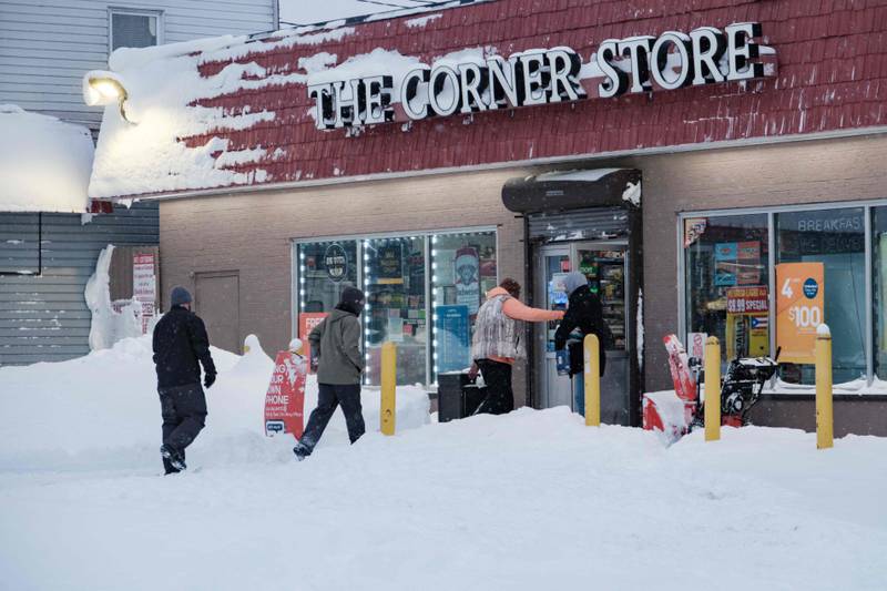 People enter a shop in Buffalo, New York, as many major grocery stores remained closed. AFP
