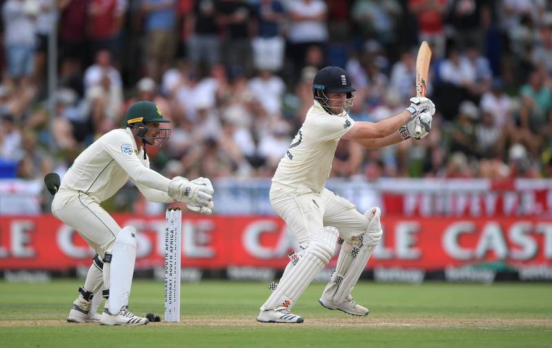 CAPE TOWN, SOUTH AFRICA - JANUARY 05: England batsman Dom Sibley drives towards the boundary watched by Quinton de Kock during Day Three of the Second Test between South Africa and England at Newlands on January 05, 2020 in Cape Town, South Africa. (Photo by Stu Forster/Getty Images)