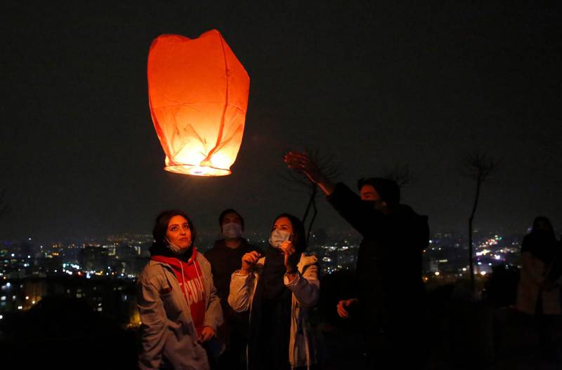 Women release a wish lantern for the Charshanbeh Suri fire festival, in Iran's capital Tehran. The festival dates from at least 1700 BC, and has been linked to the ancient religion of Zoroastrianism.  EPA