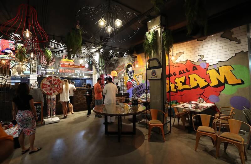 The Burgr Factory features graffiti on the walls and several fun elements such as a giant Monopoly board. Pawan Singh/The National