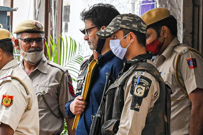 Police escort pro-independence party Jammu Kashmir Liberation Front chairman Yasin Malik to Patiala house court in New Delhi, where he was sentenced. AFP