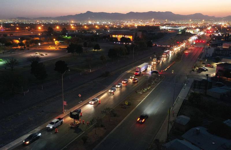 Vehicles wait to cross the US-Mexico border and enter Ciudad Juarez, amid surging Covid-19 cases in the Mexican border city and the US border city of El Paso, Texas.  AFP