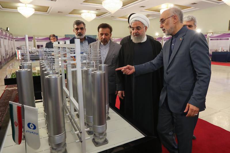 epa07687230 (FILE) - A handout file picture made available by the presidential office shows Iranian President Hassan Rouhani (C) and the head of Iran nuclear technology organization Ali Akbar Salehi inspecting nuclear technology on the occasion of Iran National Nuclear Technology Day in Tehran, Iran, 09 April 2019 (reissued 01 July 2019). According to Iranian media on 01 July 2019, Iran has passed the limit on its stockpile of low-enriched uranium by exceeding of 300kg set in a landmark 2015 nuclear deal made with world powers. The International Atomic Energy Agency (IAEA) said it will file a report.  EPA/IRANIAN PRESIDENCY OFFICE HANDOU  HANDOUT EDITORIAL USE ONLY/NO SALES *** Local Caption *** 55176102