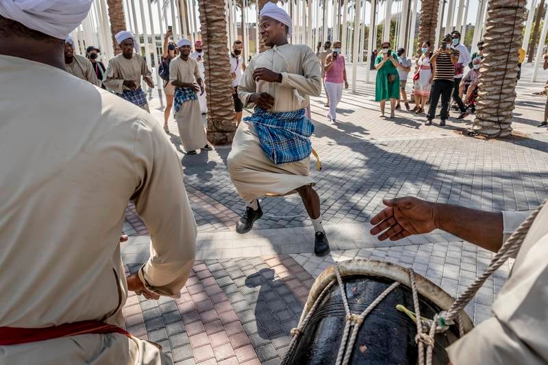 A mixture of Emirati's and Omani's perform a traditional dance routine with traditional instruments native to the border areas that the two countries share. (Photo: Antonie Robertson / The National)
