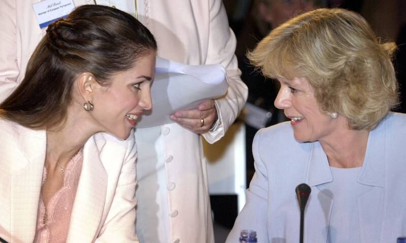 Queen Rania of Jordan, left, chats with the queen consort at an event in Lisbon in 2002. Reuters