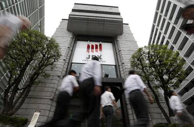 Pedestrians walk past the Tokyo Stock Exchange, operated by Japan Exchange Group. Japan's Nikkei index fell 0.1 per cent on Monday. Tomohiro Ohsumi/Bloomberg
