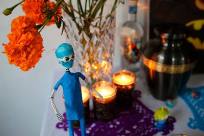 A paper skeleton dressed as a doctor adorns a Day of the Dead altar for Daniel Silva Montenegro, a doctor who died from symptoms related to Covid-19, made by his wife Kenya Navidad at her home in Mexico City. AP Photo