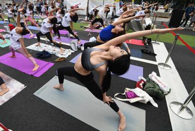 Participants take part in a mass yoga event at Gwanghwamun Square in Seoul in celebration of the upcoming International Yoga Day to be held on June 21. Jung Yeon-je / AFP