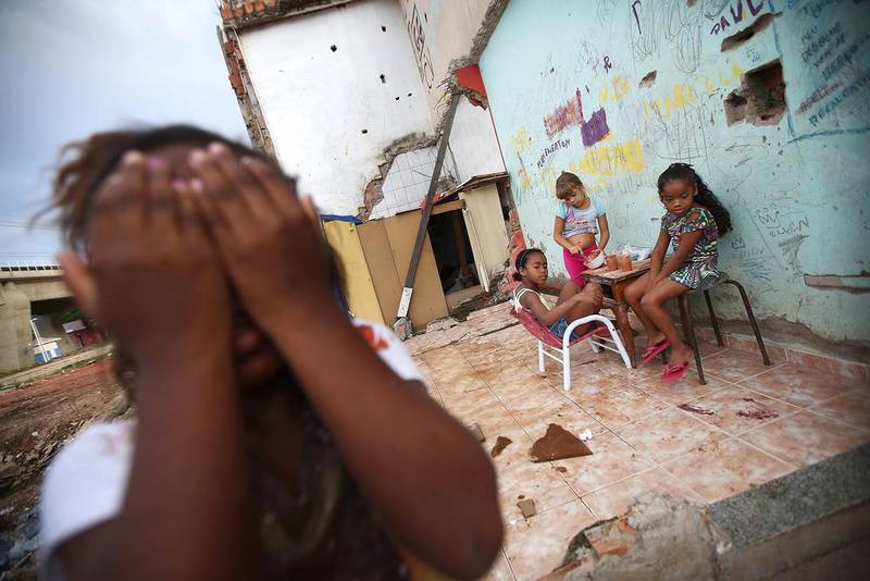 Children play in the rubble of a former home next to construction in the Manguinhos ‘favela’ in Rio de Janeiro, Brazil. Mario Tama / Getty Images