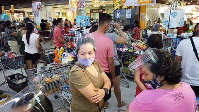 Residents crowd a grocery store to buy essential goods in Legaspi, Albay. AFP