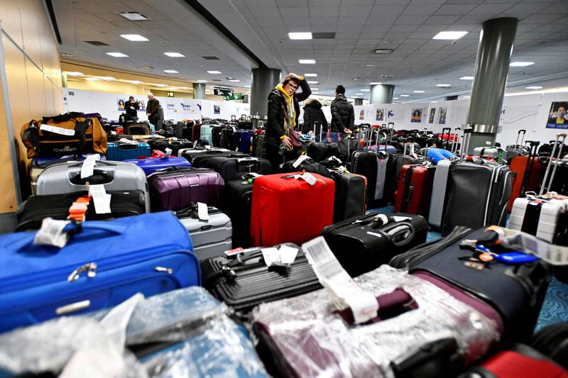 Passengers search for luggage following flight cancellations caused by a winter storm at Vancouver International Airport, British Columbia. Reuters