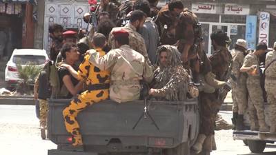 An image grab taken from AFP TV on December 2, 2017 shows Houthi rebel fighters riding on the back of a pickup truck in the capital Sanaa. AFP