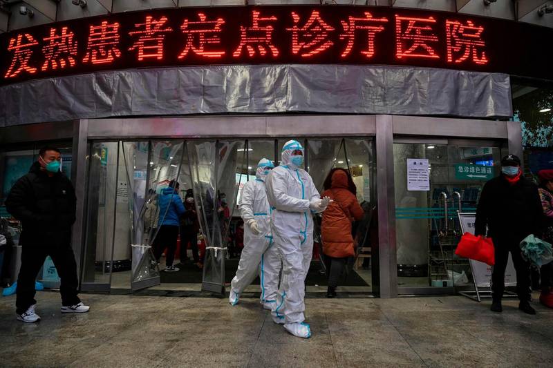 Medical staff members wearing protective clothing to help stop the spread of a deadly virus which began in the city, walk at the Wuhan Red Cross Hospital in Wuhan.  AFP