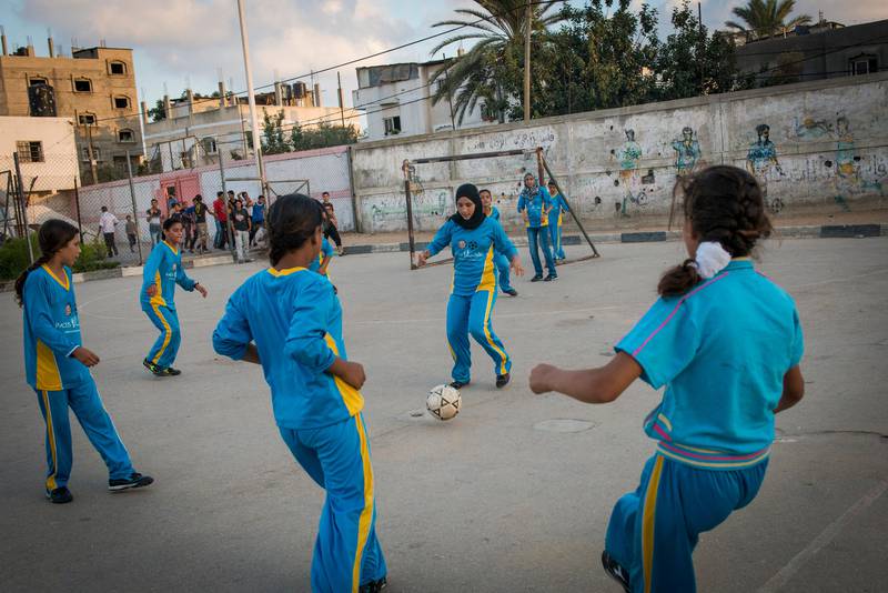 Girls play football in the Northern Gaza town of Beit Lahiyah. Women in Gaza typically do all types of sports till the age of 16, when family pressure forces them to stop as many families seek to find husbands for them.