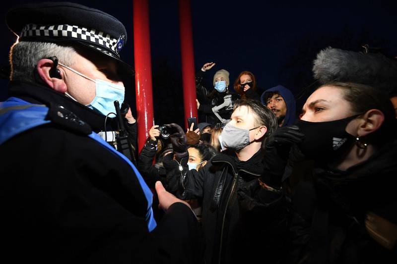 People paying tribute to murder victim Sarah Everard are involved in a confrontation with police, at Clapham Common, London. Crowds gathered despite the Reclaim These Streets vigil being officially cancelled. AP Photo