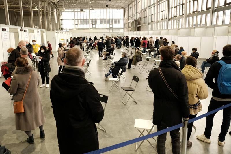 People wait to receive the coronavirus vaccine at a temporary vaccination centre at the International Fair in Poznan, Poland. Reuters