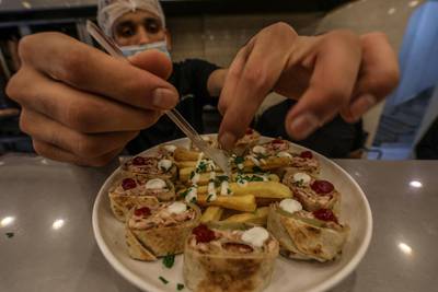 A Palestinian cook, wearing a protective face mask, works at a resturant amid the ongoing coronavirus COVID-19 pandemic in Gaza City. The Ministry of Interior in Gaza City announced new measures in light of the increasing number of new infections with the Coronavirus, which are the closure of schools, universities, mosques and government ministries until further notice, as well as work from six in the morning until six in the evening only, and on Friday and Saturday of every week, a comprehensive closure.  EPA