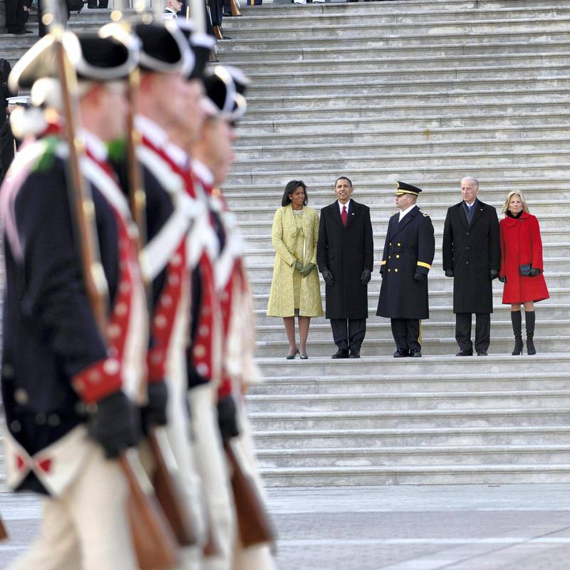 U.S. President Barack Obama, his wife Michelle (L), Vice President Joseph Biden (2nd R) and his wife Jill (R) are escorted by Major General Richard Rowe as they review the troops from the steps of the U.S Capitol Building after Obama was sworn in as the 44th president of the United States during the 56th presidential inauguration ceremony in Washington January 20, 2009. Barack Obama became the first black U.S. president on Tuesday and declared it is time to set aside petty differences and embark on a new era of responsibility to repair the country and its image abroad.    REUTERS/Tannen Maury/Pool       (UNITED STATES)