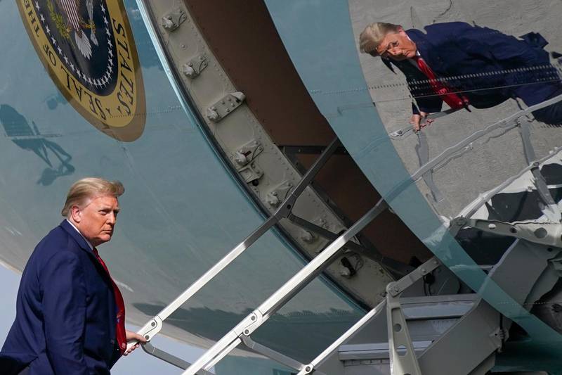 FILE - In this Dec. 31, 2020, file photo President Donald Trump boards Air Force One at Palm Beach International Airport in West Palm Beach, Fla. (AP Photo/Patrick Semansky, File)