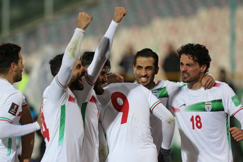 Iran's forward Mehdi Taremi, number 9, celebrates his opening goal with his teammates during the 2022 Qatar World Cup qualifier against Iraq at the Azadi Stadium in Tehran on Thursday, January 27, 2022. AFP
