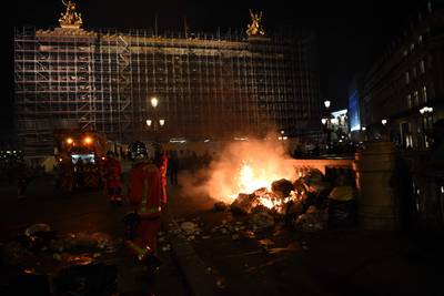 Firefighters extinguish a fire at the Place de l'Opera on Monday night. AFP