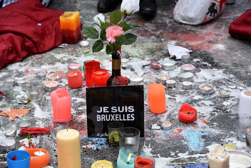 A sign reading ‘I am Brussels’ (Je suis Bruxelles) sits among candles and flowers at a makeshift memorial at Place de la Bourse (Beursplein) in Brussels on March 23, 2016. Patrik Stollarz / Agence France-Presse