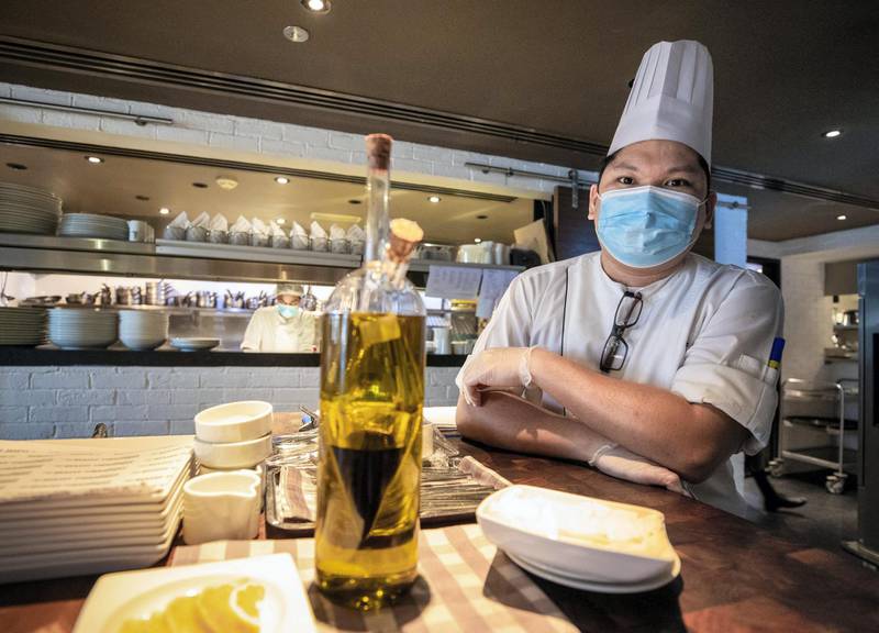 Abu Dhabi, United Arab Emirates, July 23, 2020.   Le Royal Meridien Hotel  Abu Dhabi Covid-19 awareness signages at the Market Kitchen Restaurant.  A chef with mask and gloves at the kitchen.Victor Besa  / The NationalSection: NAFor:  Standalone / Stock Images