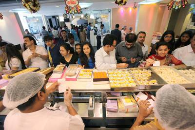 DUBAI , UNITED ARAB EMIRATES  –  Nov 13 :  People buying sweets on Diwali festival at the Bikanervala restaurant & sweet shop in Karama in Dubai. ( Pawan Singh / The National ) For News.