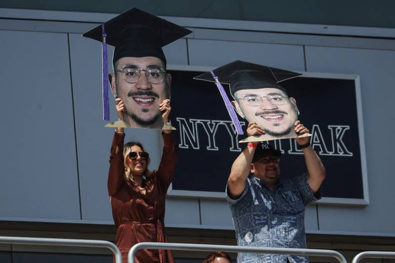 Family and friends held up cardboard cutouts of the faces of graduating students in a show of pride. Reuters