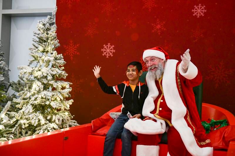 Ashrut Jena, five, visits Santa at Galleria Mall, Abu Dhabi. Khushnum Bhandari / The National