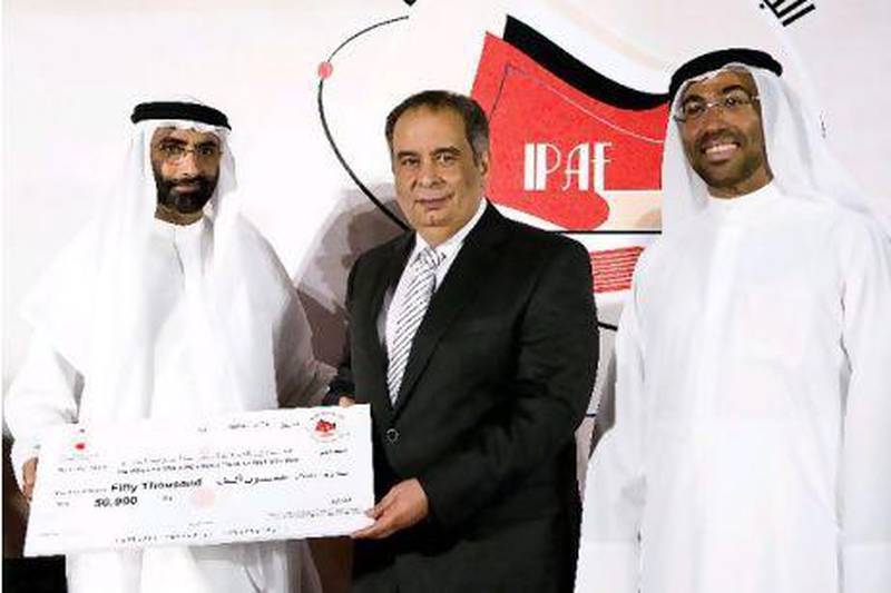 From left, Mohammed Ahmed Al Bawardi, undersecretary of Sheikh Mohammed bin Zayed, Crown Prince of Abu Dhabi, the Egyptian author Youssef Ziedan and the managing director of the Emirates Foundation, Ahmed Ali Al Sayegh, awarding the author with the 2009 International Prize for Arabic Fiction for his novel Azazel.